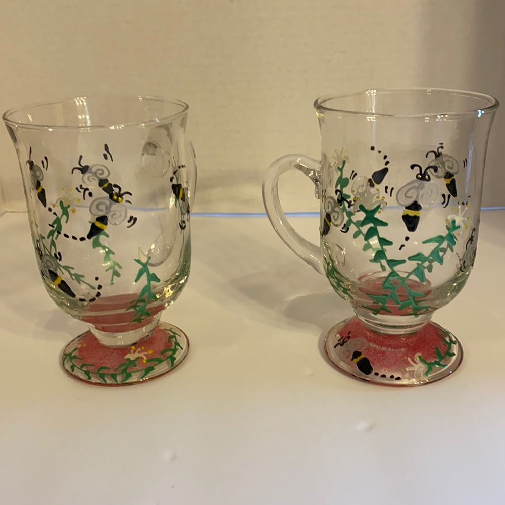 Two hand painted footed glass mugs.